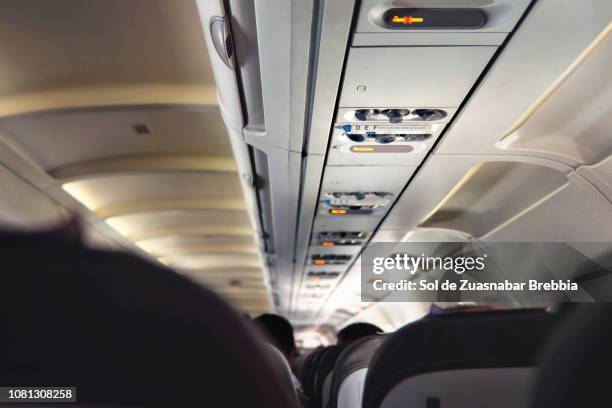 interior of a commercial airplane, focus on the sign of the seats numbered from d to f. - aisle seat airline stock-fotos und bilder