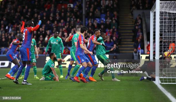 Ben Foster of Watford attempts to clear the ball after it rebounds off Craig Cathcart as Crystal Palace score their team's first goal during the...