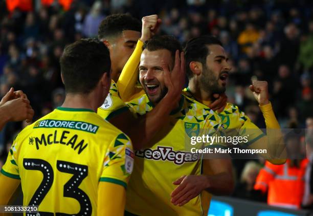 Jordan Rhodes of Norwich City celebrates with teammates after scoring his team's first goal during the Sky Bet Championship match between West...