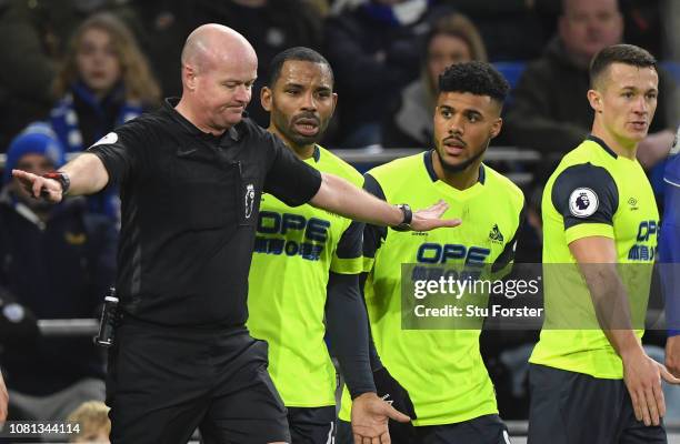 Referee Lee Mason changes his mind over awarding Huddersfield a penalty as the Huddersfield players react to the news during the Premier League match...