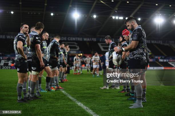 Members of the Ospreys side cut dejected figures after defeat to Worcester Warriors during the Challenge Cup match between Ospreys and Worcester...