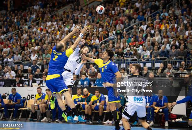 Henrique Teixeira of Team Brasilien, Steffen Faeth of DHB, Jose Toledo of Team Brasilien and Martin Strobel of DHB during the handball world...