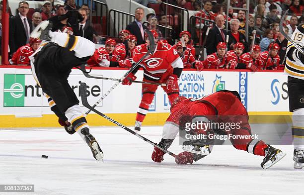 Johnny Boychuk of the Boston Bruins collides with Jeff Skinner of the Carolina Hurricanes during an NHL game on January 18, 2011 at RBC Center in...