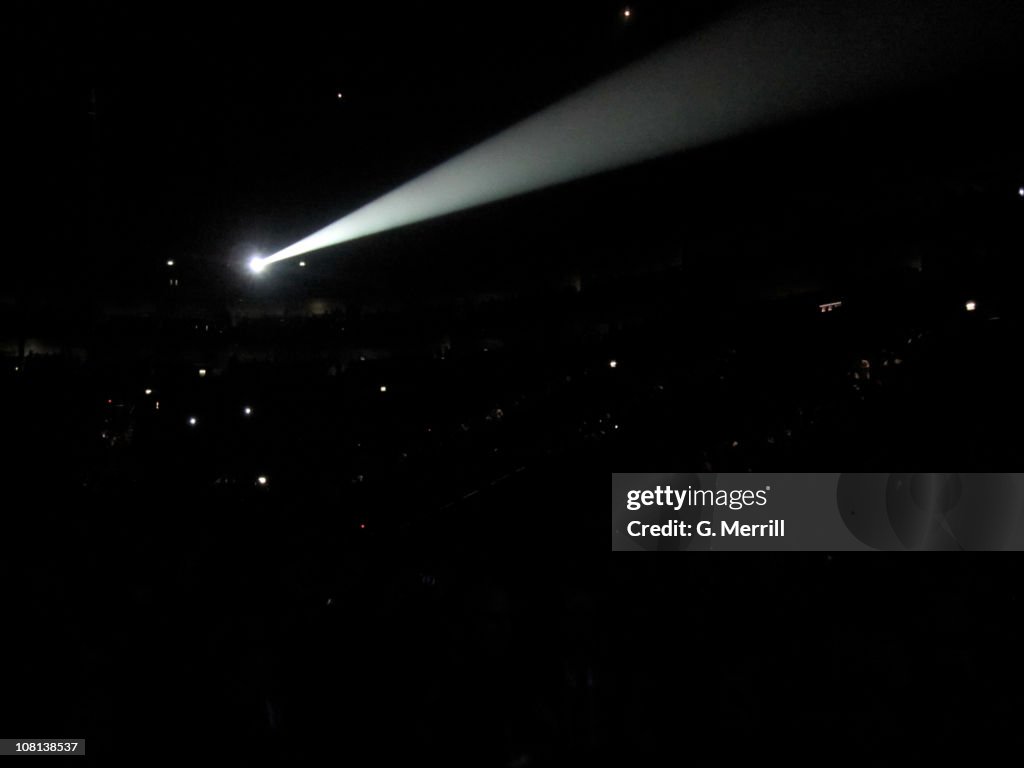 Spotlight in front of massive crowd