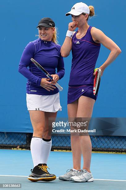 Bethanie Mattek-Sands and Meghann Shaughnessy of the United States of America talk tactics during their first round doubles match against Kirsten...