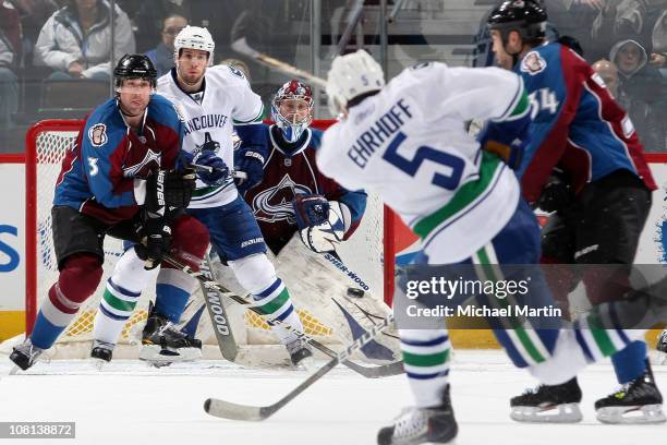 Goaltender Craig Anderson of the Colorado Avalanche watches the shot of Christian Ehrhoff of the Vancouver Canucks as Ryan O'Byrne of the Avalanche...