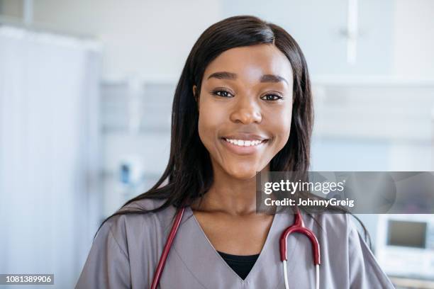 portrait of african medical student in her 20s smiling towards camera - nurse headshot stock pictures, royalty-free photos & images