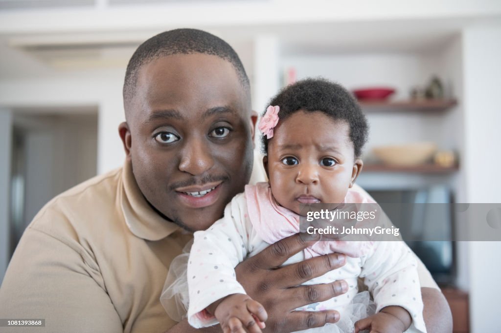 Proud father holding baby girl