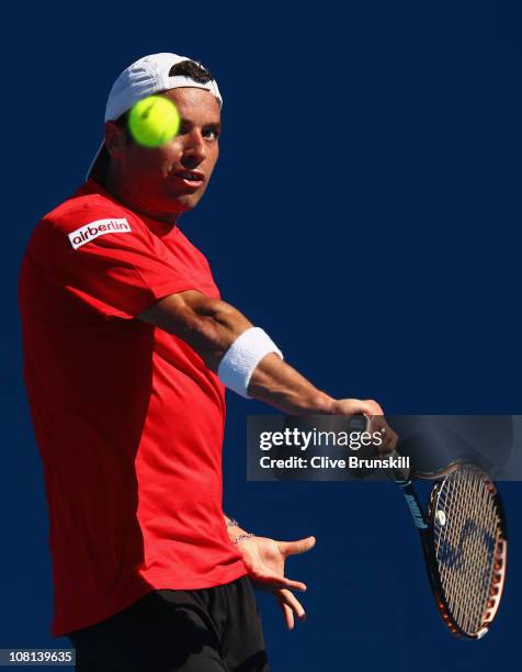 Albert Montanes of Spain plays a backhand in his second round match against Xavier Malisse of Belgium during day three of the 2011 Australian Open at...