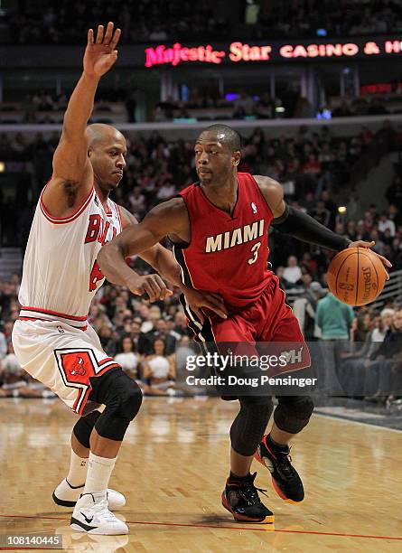 Dwyane Wade of the Miami Heat drives the ball against Keith Bogans of the Chicago Bulls at the United Center on January 15, 2011 in Chicago,...