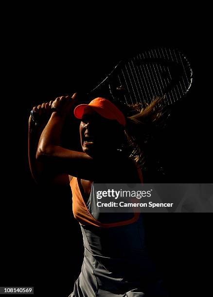 Maria Sharapova of Russia plays a forehand in her second round match against Virginie Razzano of France during day three of the 2011 Australian Open...