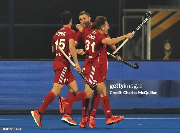 Harry Martin of England celebrates as he scores his team's third goal with Phil Roper and Will Calnan during the FIH Men's Hockey World Cup quarter...