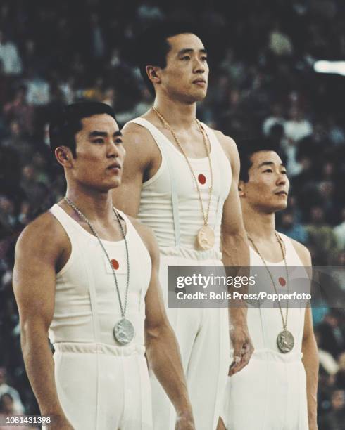 View of the medal winners of the Men's artistic individual all-around gymnastics event with, from left, silver medallist Eizo Kenmotsu of Japan, gold...