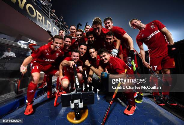 England players take a selfie photograph as they celebrate victory after the FIH Men's Hockey World Cup quarter final match between Argentina and...