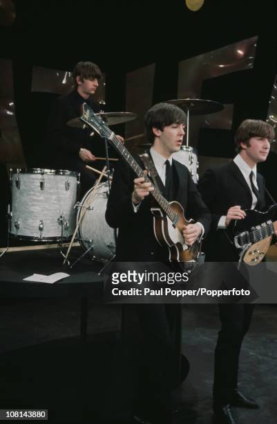 Members of British Rock group the Beatles, perform on the set of 'The Ed Sullivan Show' at CBS's Studio 50, New York, New York, February 8, 1964....