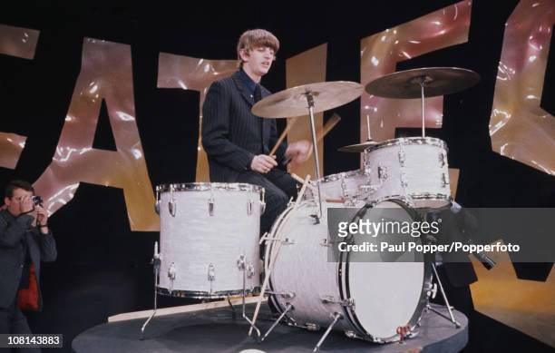 British Rock musician Ringo Starr, of the group the Beatles, plays drums perform on the set of 'The Ed Sullivan Show' at CBS's Studio 50, New York,...