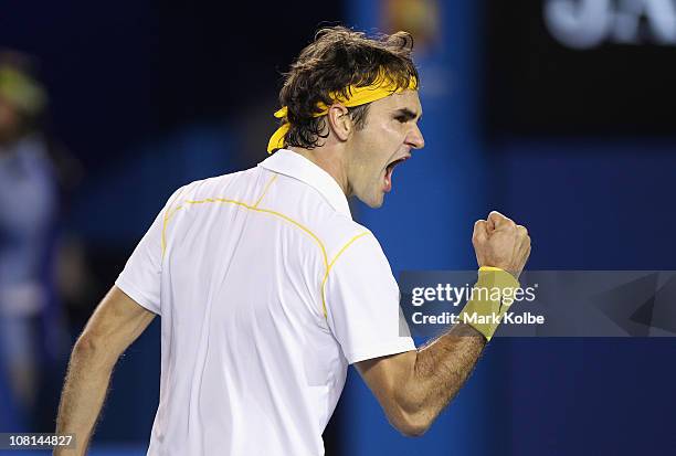 Roger Federer of Switzerland celebrates match point in his second round match against Gilles Simon of France during day three of the 2011 Australian...