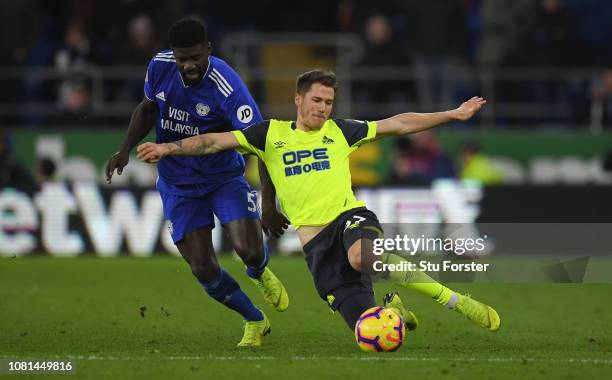 Cardiff player Bruno Ecuele Manga challenges Erik Durm of Huddersfield during the Premier League match between Cardiff City and Huddersfield Town at...