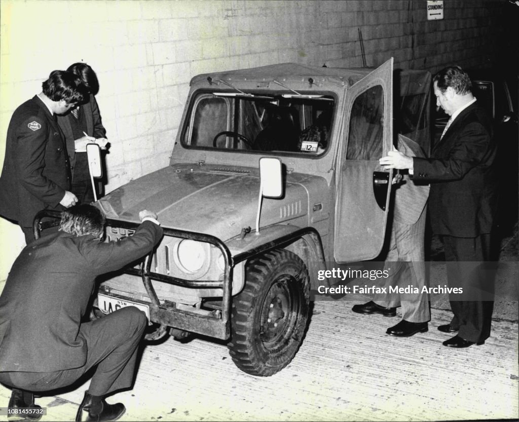 Police inspect a stolen four wheel drive vehicle used in a gun theft ...