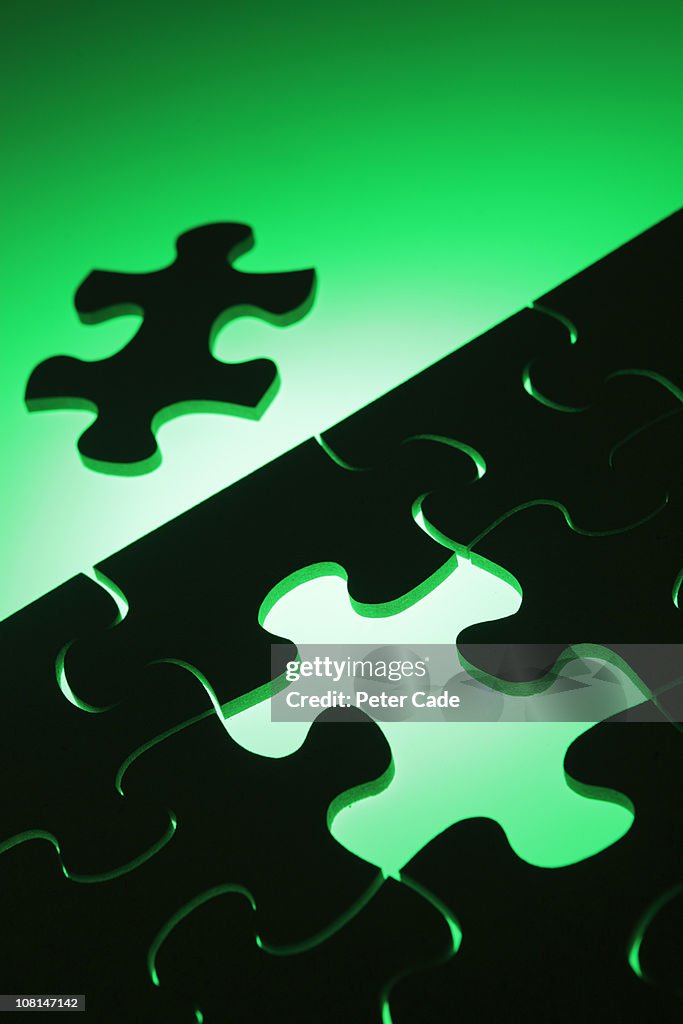 Black jigsaw green background