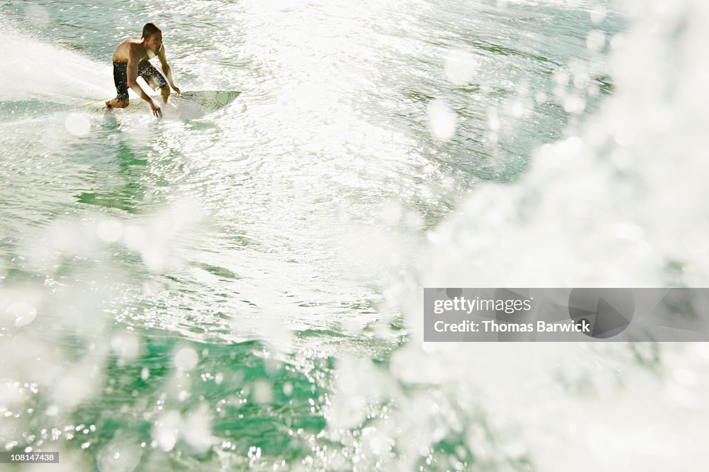 Surfer making a bottom turn on wave