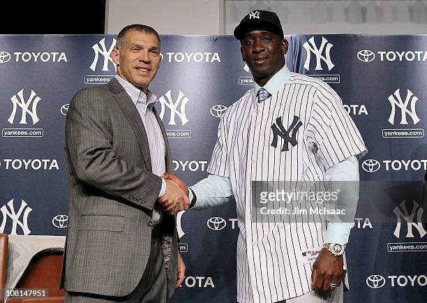 Rafael Sorianoof the New York Yankees shakes hands with manager Joe Girardi during his introduction press conference on January 19, 2011 at Yankee...