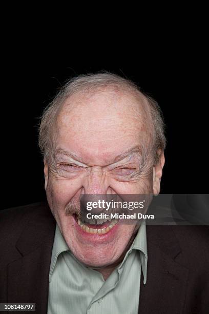 studio portrait of an elder man black background - augen zukneifen stock-fotos und bilder