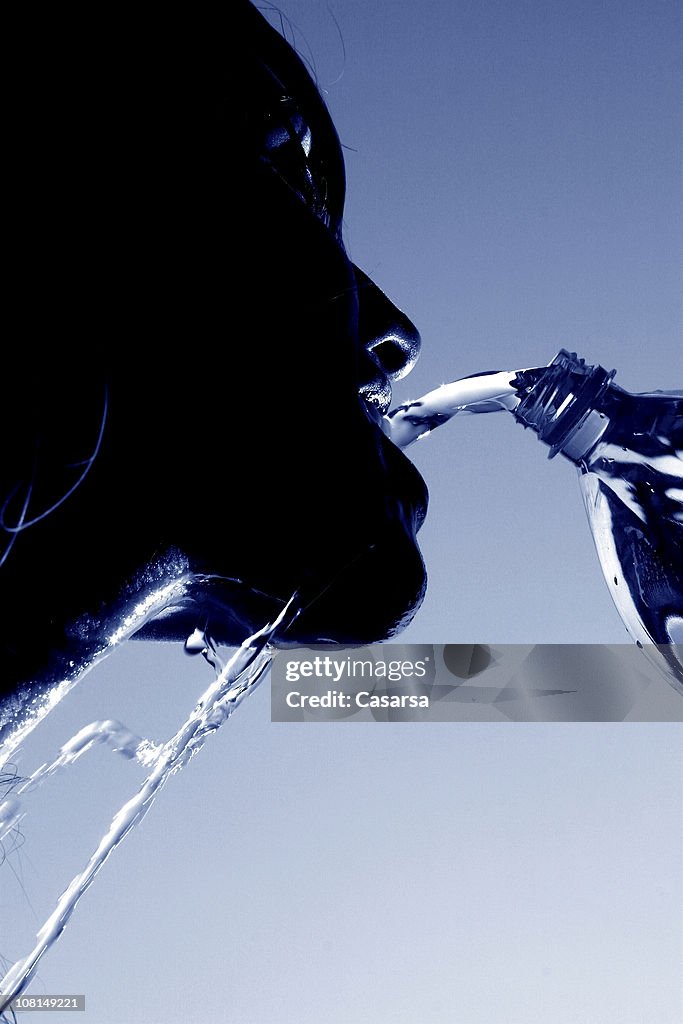 SIlhouette de jeune femme verser l'eau à la bouche, tonifiée