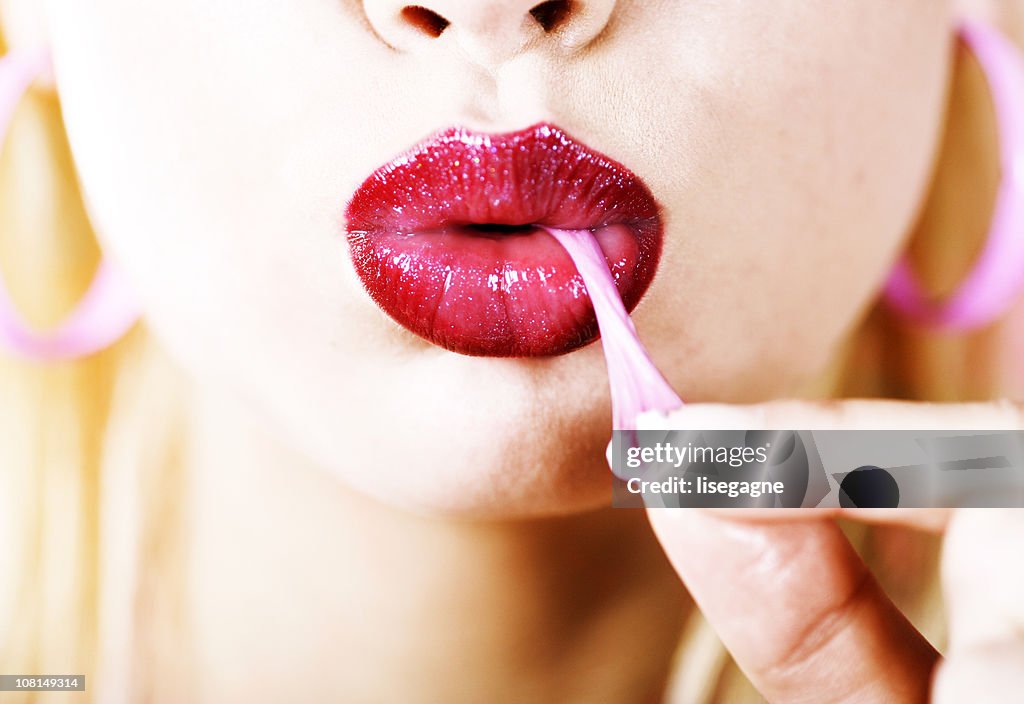Young Woman's Mouth Pulling Gum
