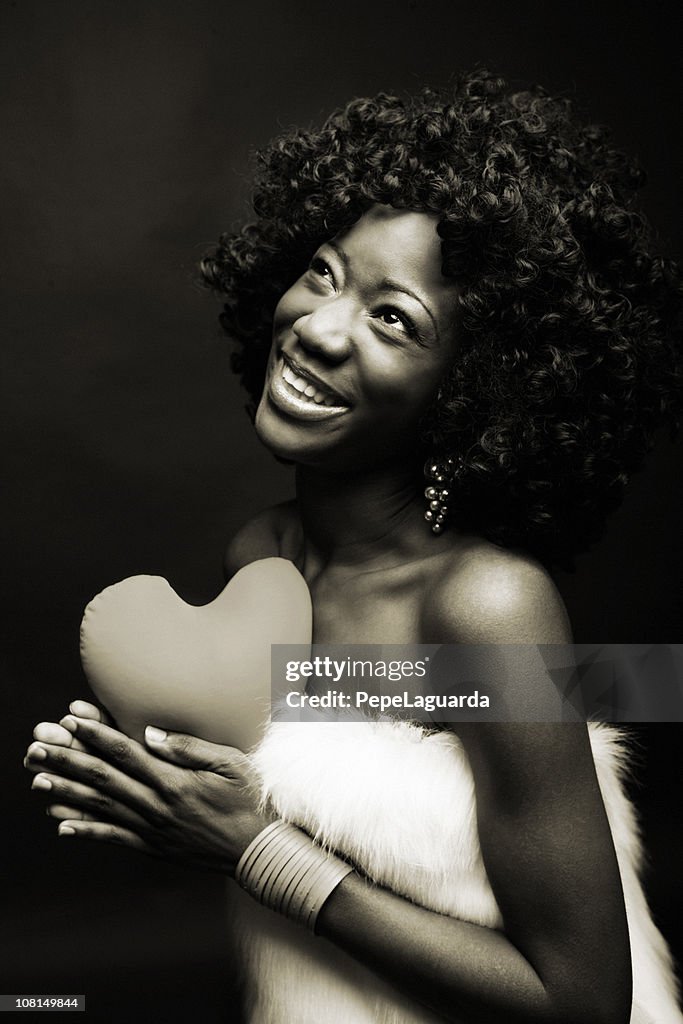 Happy Young Woman Holding Heart Pillow, Black and White