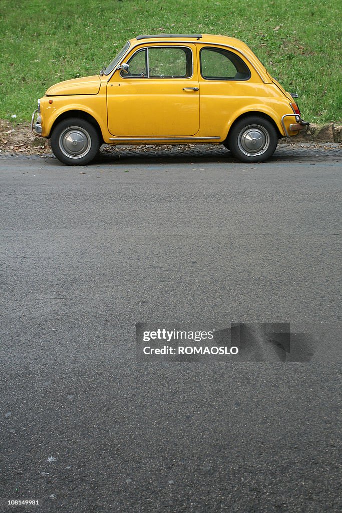 Yellow Italian vintage car in Rome, Italy