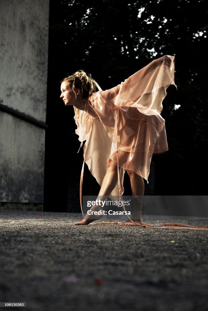 Woman Dressed as a Fairy and Posing in Courtyard