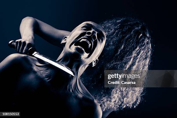 woman holding knife blade to terrified man's throat, toned - murderer stock pictures, royalty-free photos & images