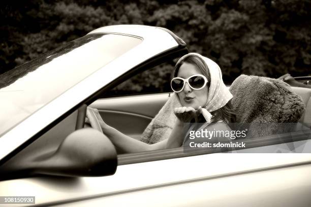 woman blowing kisses from a convertible - 20th century model car stock pictures, royalty-free photos & images