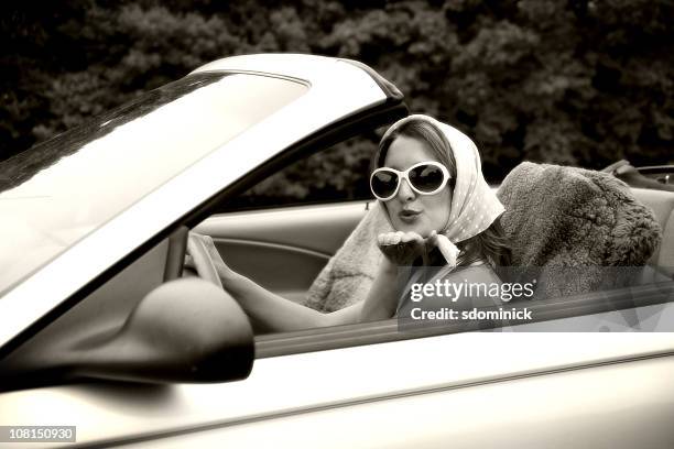 woman blowing kisses from a convertible - woman headscarf sunglasses stock pictures, royalty-free photos & images