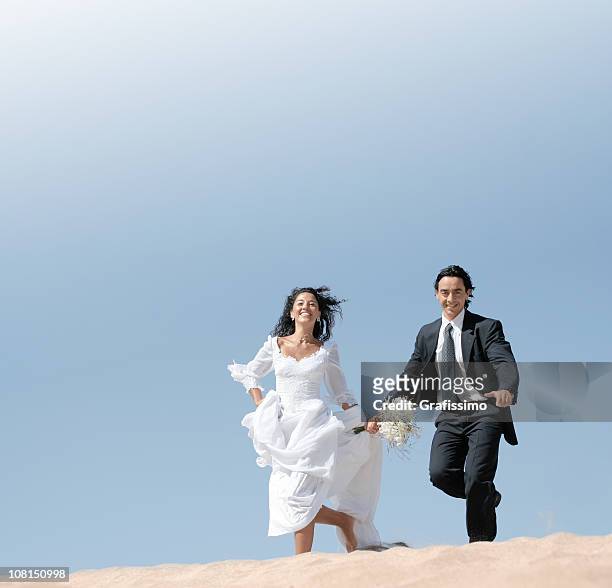bride and groom running in the dunes - bride running stock pictures, royalty-free photos & images