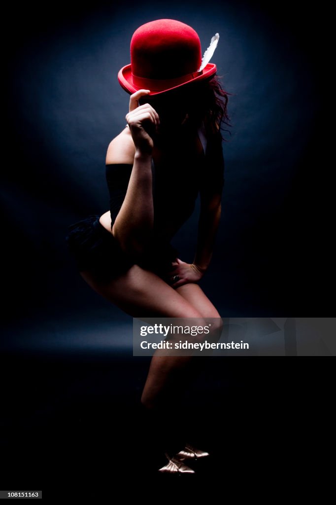 Young Woman Tipping Red Bowler Hat, Low Key