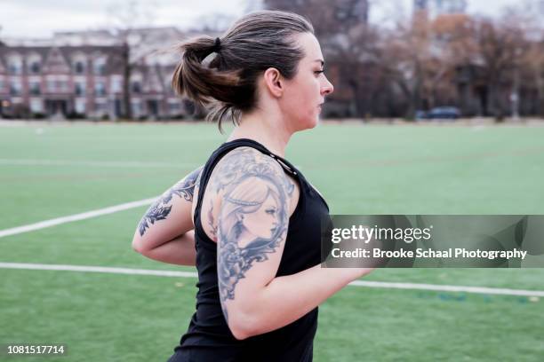 woman running on a track - running toronto stock-fotos und bilder