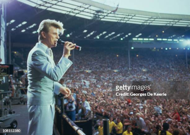 English singer David Bowie performing at the Live Aid concert at Wembley Stadium in London, 13th July 1985. The concert raised funds for famine...