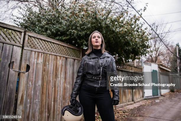 Woman in an alley way with her motorcycle