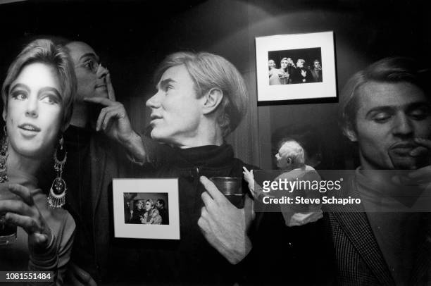 View of American photographer Steve Schapiro as he looks over a wall installation at the exhibition 'Andy Warhol: Fantastic!,' at Camera Work's CWC...