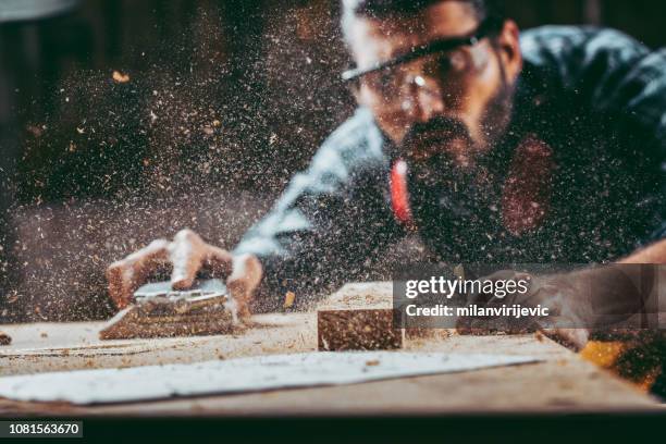 young handosme carpenter - sand paper stock pictures, royalty-free photos & images