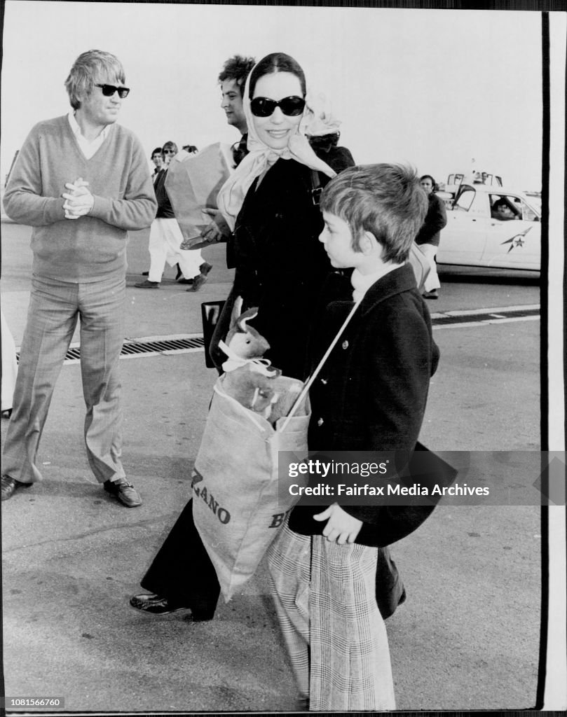Nana and her son Nicholas 6 walk across the tarmac.Greek singer Nana Mouskouri arrived in Sydney from Melbourne for concerts. Interviewd at TAA lounge , Mascot airport.