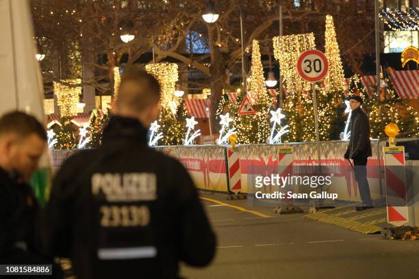 Police maintaining security stand across from barriers at the Christmas market at Breitscheidplatz on December 12, 2018 in Berlin, Germany. December...