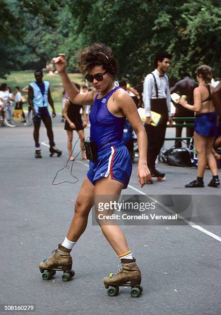 Woman listen to music on a Walkman as she roller skates in Central Park, New York City, 1988.