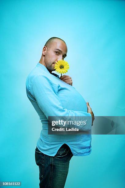 pregnant man holding daisy - crazy dad stock pictures, royalty-free photos & images