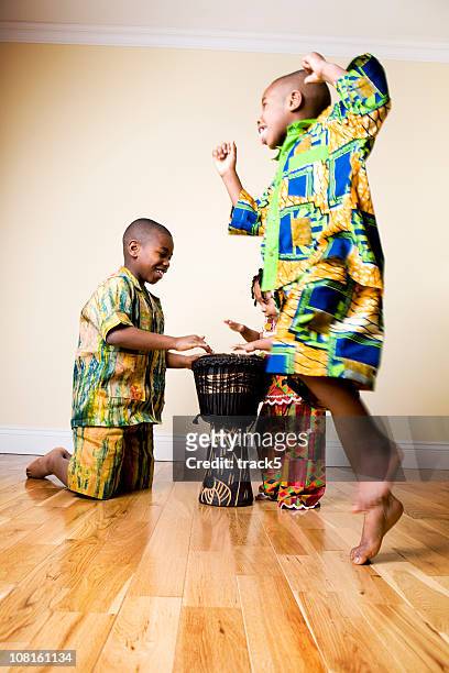 african fashion: drums and dancing children - world music stock pictures, royalty-free photos & images