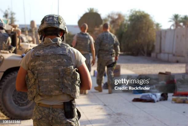 soldiers in desert fatigues with vehicles in the background - military inspection stock pictures, royalty-free photos & images