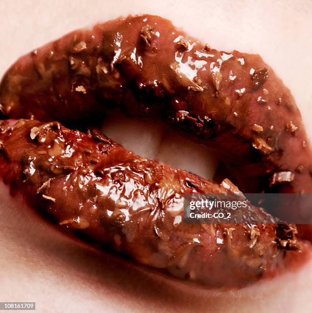 woman's lips covered in chocolate - candy lips stock pictures, royalty-free photos & images