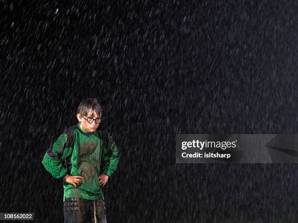fußball torhüter im regen - boy in hard hat stock-fotos und bilder